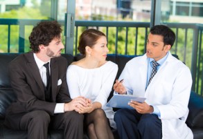 Young couple gets counseled by a doctor